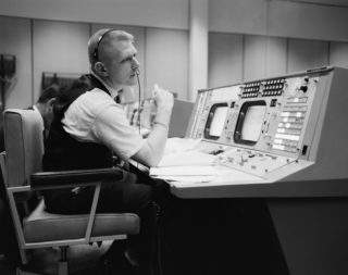 Eugene F Kranz at his console at the NASA Mission Control Center