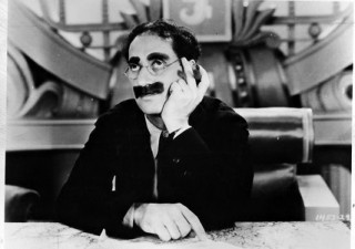 Groucho Marx , his mustache and a cigar