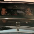 John McClane sitting up front in the Limo with Argyle - Die Hard
